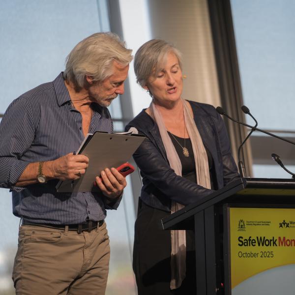 2 people standing at lectern at safety awards